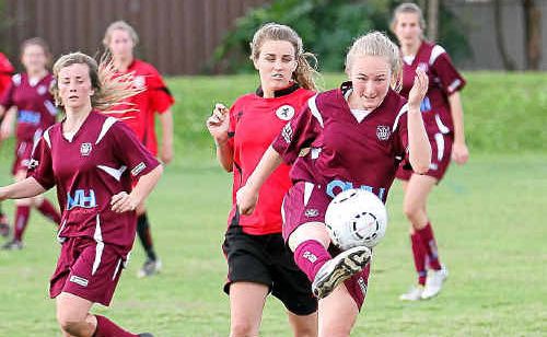 Urunga’s Rachael Devine gets her clearance kick in before the Coffs United attack closes in at Maclean St. Urunga’s Rachael Devine gets her clearance kick in before the Coffs United attack closes in at Maclean St.